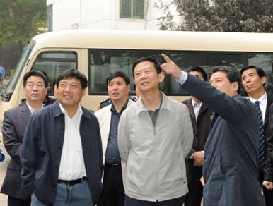 2011年集团公司董事长印建安陪同市委常委、市政法委书记丁健到一定发社区视察各项事情